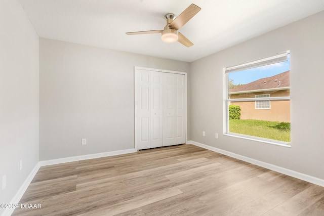 unfurnished bedroom with a closet, ceiling fan, and light hardwood / wood-style flooring