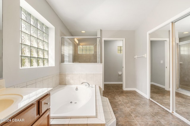 bathroom featuring tile patterned flooring, vanity, and independent shower and bath