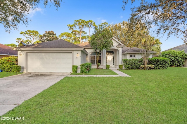 single story home featuring a garage and a front lawn