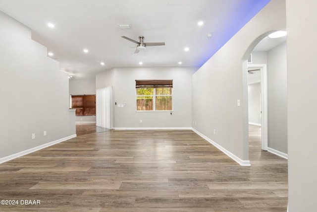 unfurnished living room with hardwood / wood-style flooring and ceiling fan