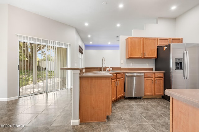 kitchen featuring stainless steel appliances, light tile patterned flooring, sink, and kitchen peninsula