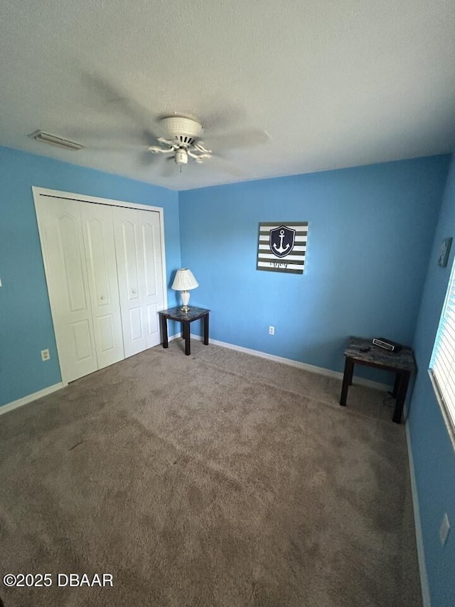 539 Lake Bridge Dr, Ormond Beach, FL 32174 - unfurnished bedroom with a closet, carpet flooring, baseboards, and a textured ceiling