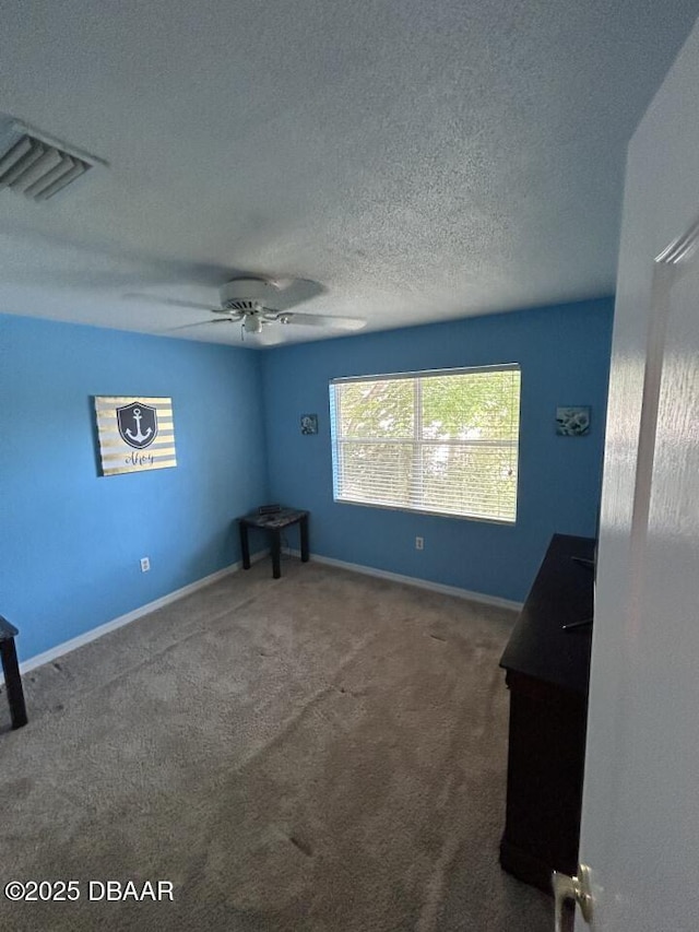 539 Lake Bridge Dr, Ormond Beach, FL 32174 - unfurnished bedroom featuring carpet, ceiling fan, baseboards, and a textured ceiling