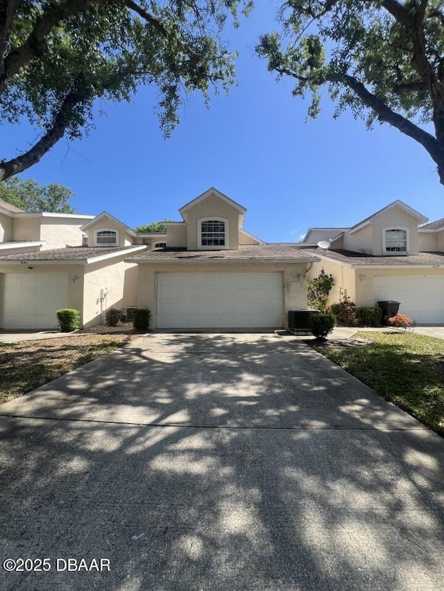 539 Lake Bridge Dr, Ormond Beach, FL 32174 - view of front of home with stucco siding, concrete driveway, and central AC