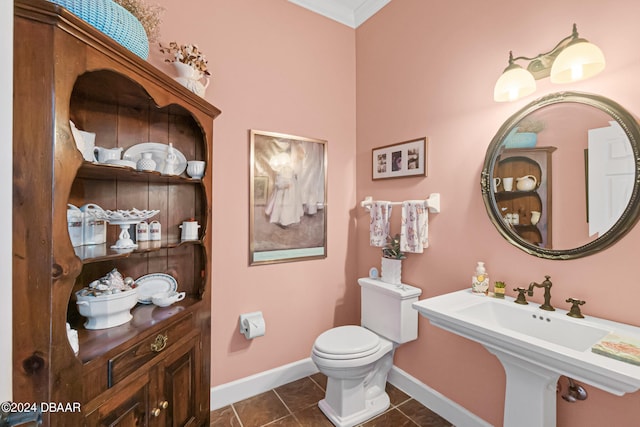 bathroom with tile patterned floors, toilet, and crown molding