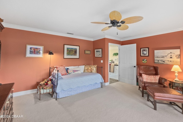 carpeted bedroom featuring ceiling fan and crown molding