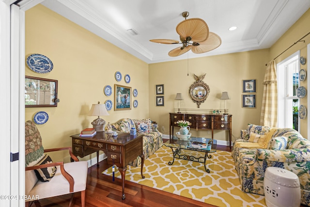 living room featuring hardwood / wood-style floors, ceiling fan, and crown molding