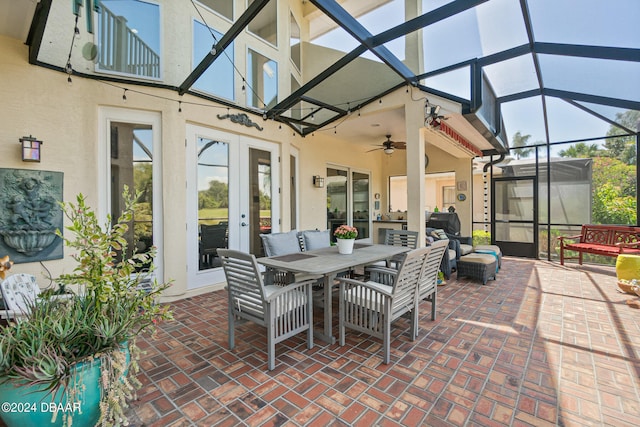 view of patio with ceiling fan, a lanai, and french doors