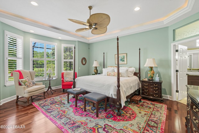 bedroom featuring ceiling fan, crown molding, dark hardwood / wood-style floors, and a raised ceiling