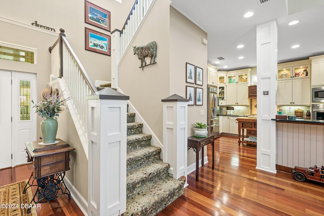 staircase with wood-type flooring