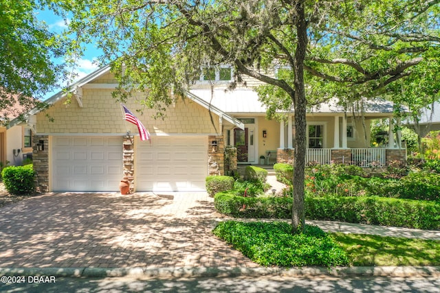 craftsman-style home with a garage and covered porch