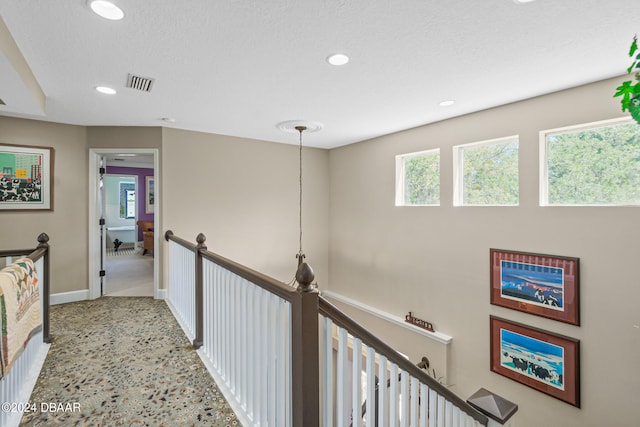 hallway with a textured ceiling