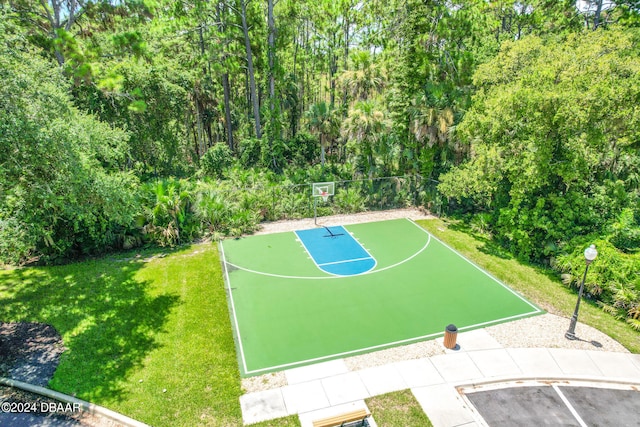 view of sport court featuring a yard