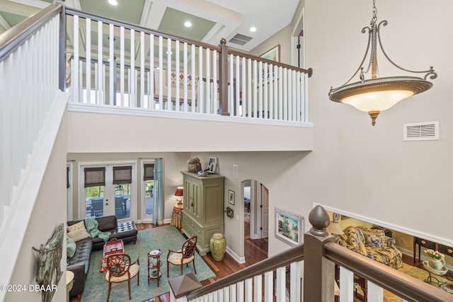 stairway featuring a high ceiling and wood-type flooring