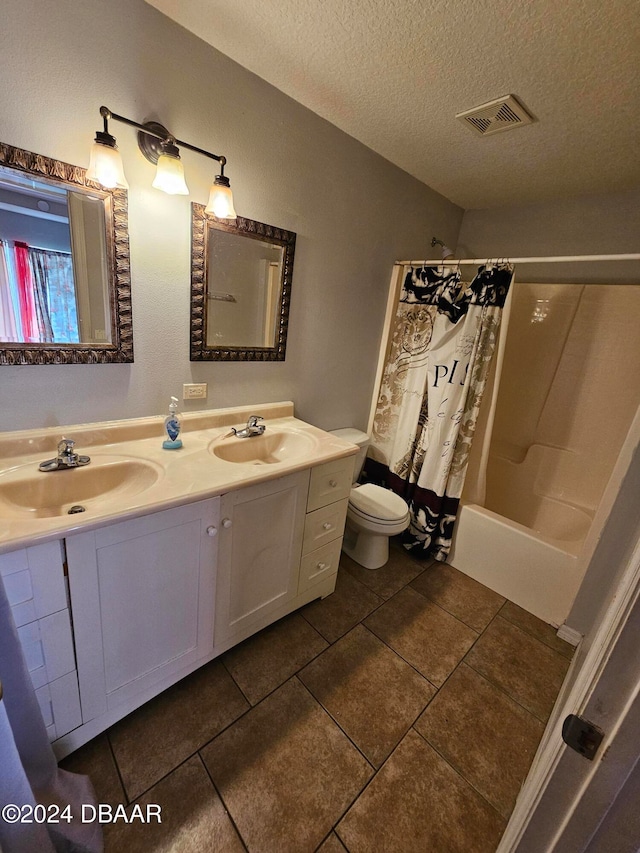 full bathroom featuring toilet, tile patterned flooring, a textured ceiling, vanity, and shower / bath combination with curtain