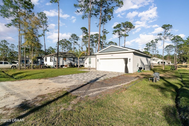 view of front facade with a garage, decorative driveway, a front yard, and stucco siding