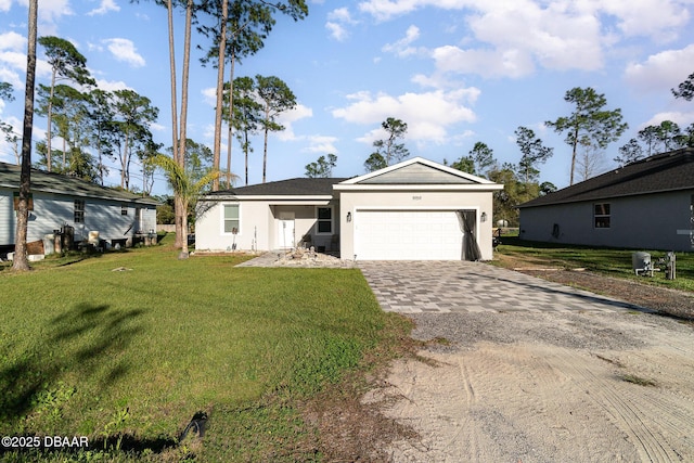 ranch-style house with an attached garage, stucco siding, decorative driveway, and a front yard