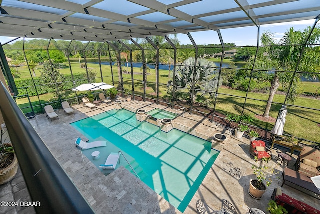 view of swimming pool with a patio, a yard, and a lanai