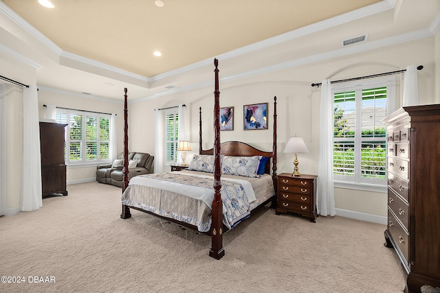 bedroom with light colored carpet, multiple windows, and ornamental molding