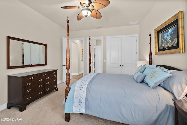 bedroom with light colored carpet, ceiling fan, and a closet