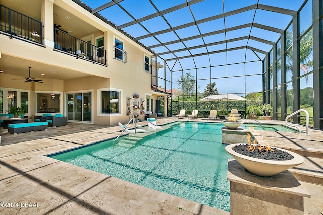 view of swimming pool with a hot tub, glass enclosure, a patio, and ceiling fan