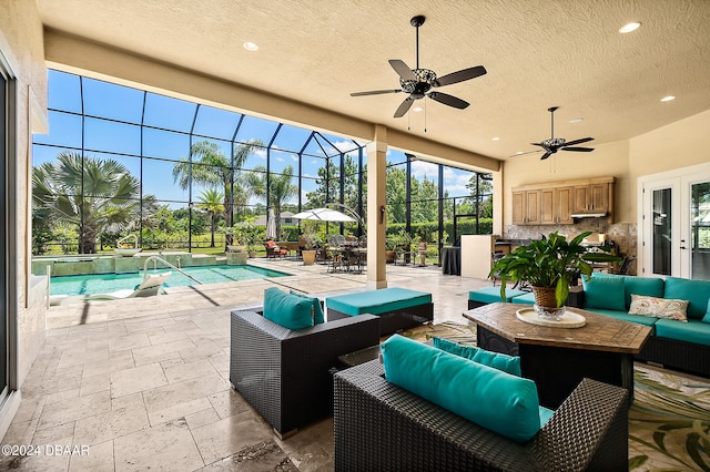 view of patio / terrace with ceiling fan, glass enclosure, and an outdoor living space