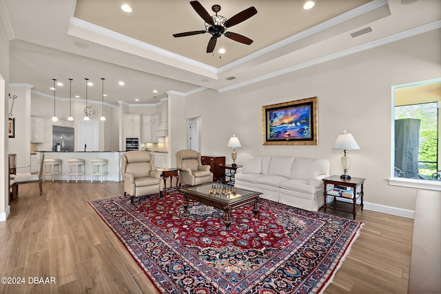 living room with light hardwood / wood-style flooring and crown molding