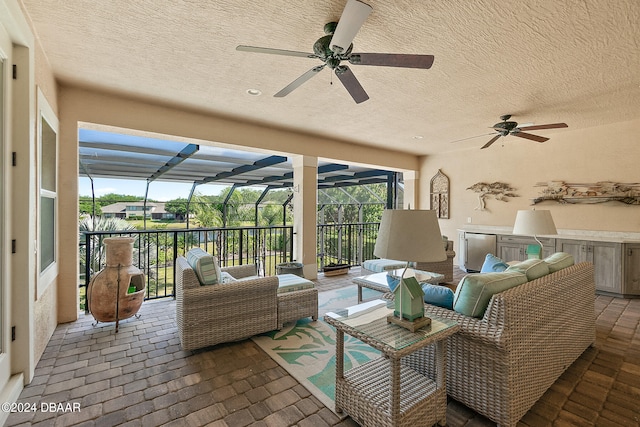 exterior space featuring glass enclosure, an outdoor hangout area, and ceiling fan