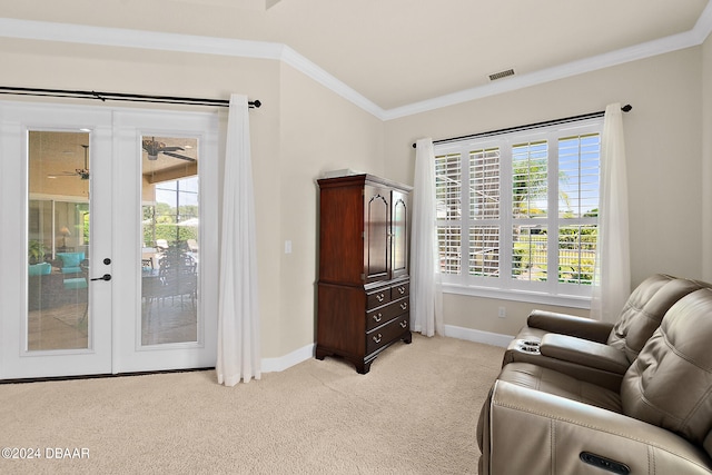 living area featuring french doors, light carpet, and crown molding