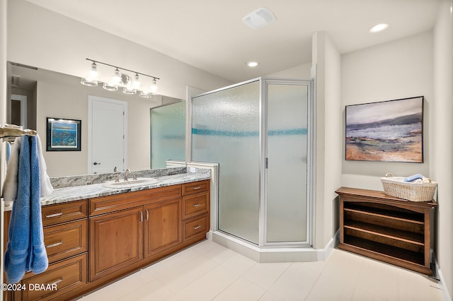 bathroom with tile patterned flooring, an enclosed shower, and vanity