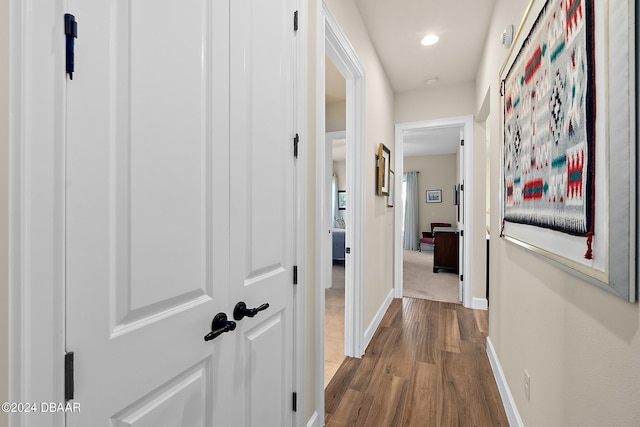 hallway with hardwood / wood-style floors