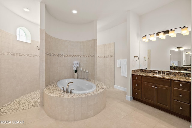 bathroom featuring independent shower and bath, vanity, and tile patterned floors