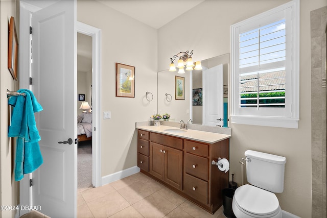 bathroom with vanity, tile patterned flooring, and toilet