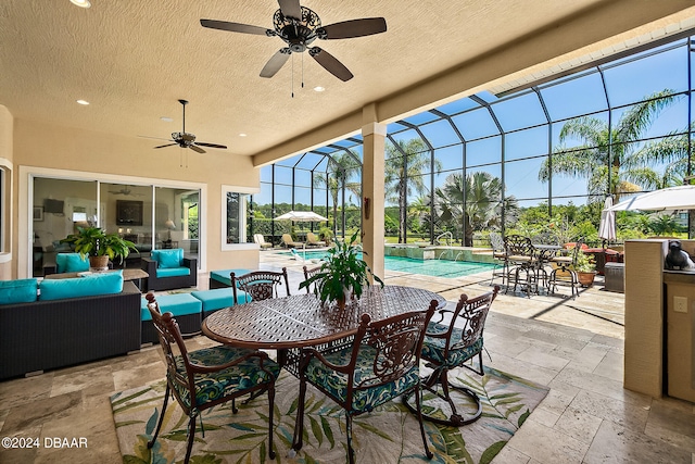 view of patio / terrace featuring a lanai, ceiling fan, and an outdoor living space