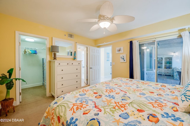 bedroom with ceiling fan, light colored carpet, a walk in closet, and access to outside