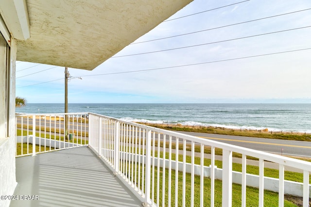 balcony featuring a water view and a beach view