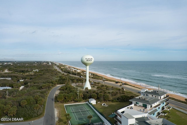 drone / aerial view featuring a water view and a beach view