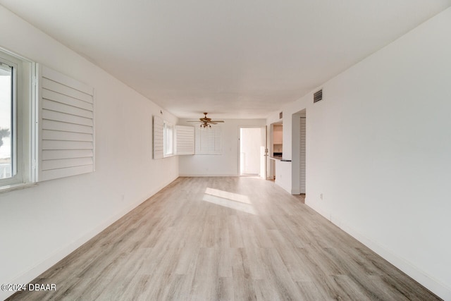 empty room with light hardwood / wood-style flooring and ceiling fan