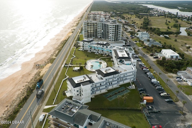 drone / aerial view featuring a beach view and a water view