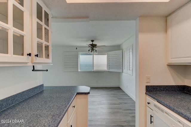 kitchen featuring dishwasher, light wood-type flooring, ceiling fan, and white cabinets