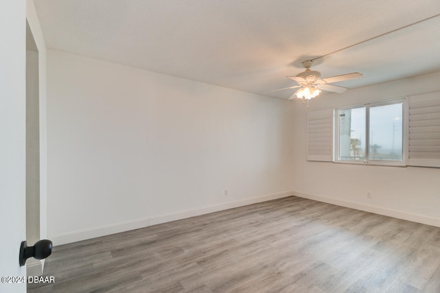 empty room featuring hardwood / wood-style flooring and ceiling fan