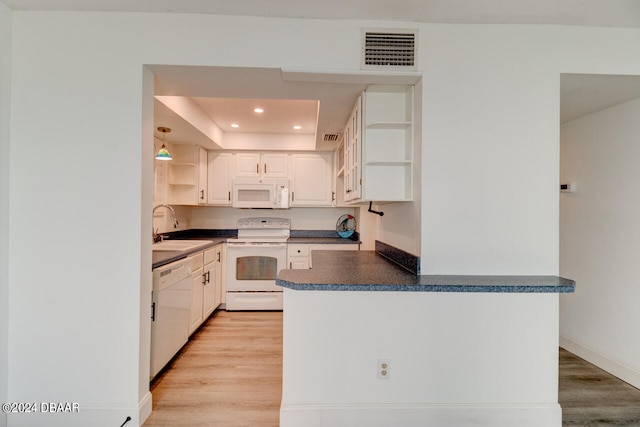 kitchen with white cabinetry, white appliances, sink, and light hardwood / wood-style floors