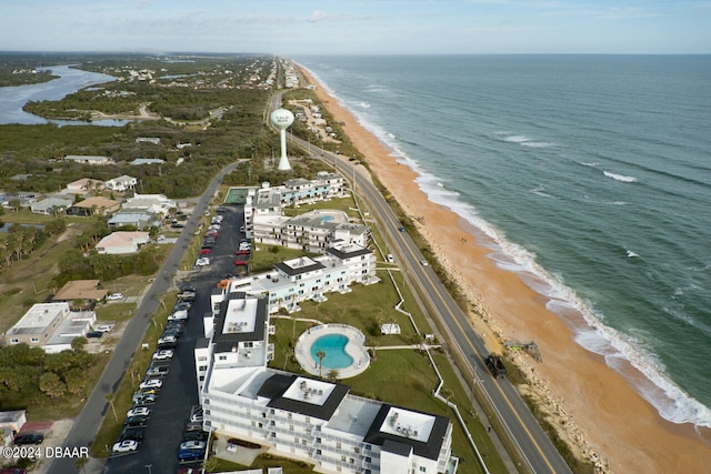 birds eye view of property featuring a water view and a beach view