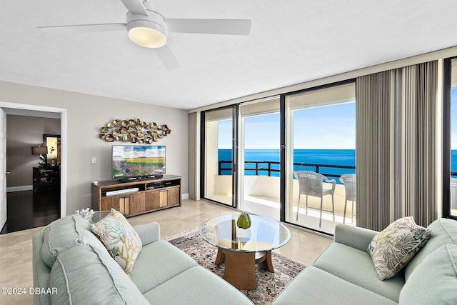 living room with expansive windows and ceiling fan