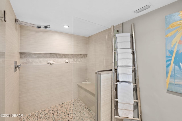 bathroom with a tile shower