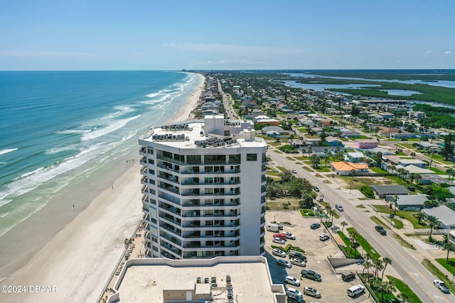 bird's eye view with a water view and a beach view