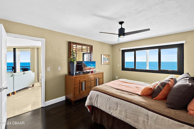 bedroom with dark wood-type flooring and ceiling fan