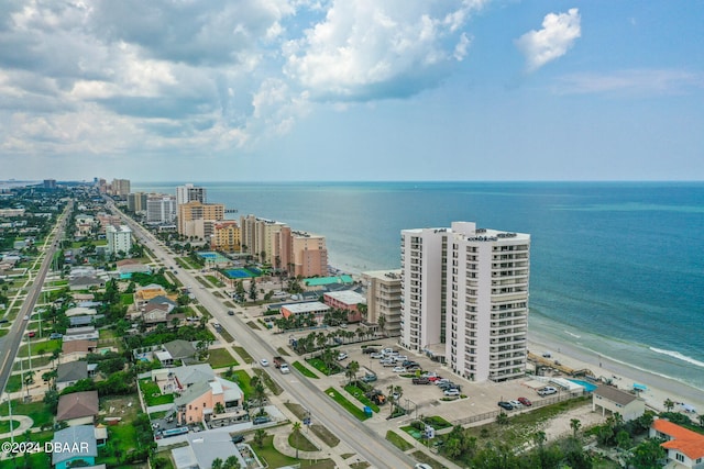 birds eye view of property featuring a view of the beach and a water view