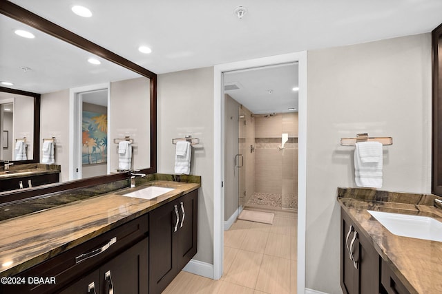 bathroom featuring walk in shower, vanity, and tile patterned floors