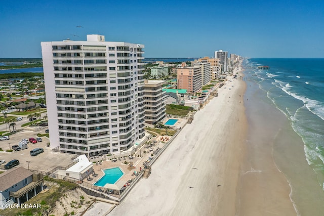 drone / aerial view with a water view and a beach view